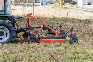 Wall Mural - In autumn tractor is used to trim remove small branches that are grow on ground