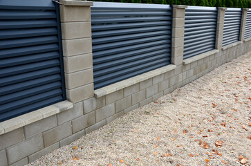 metal fillings of the fence with an underlay of concrete blocks. a metal aluminum fence will provide