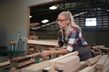 Contemporary Carpenter Working, Portrait of modern carpenter making wood furniture while working in joinery lit by sunlight with factory background on small business concept, copy space