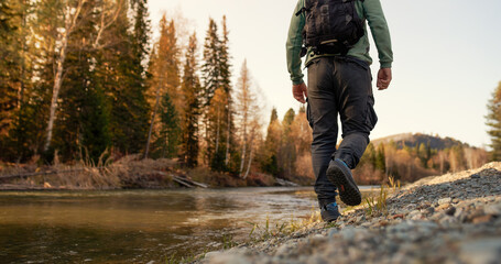 men's footsteps on the beach of river 