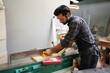 © FotoArtist - Contemporary Carpenter Working, Portrait of modern carpenter making wood furniture while working in joinery lit by sunlight with factory background on small business concept, copy space