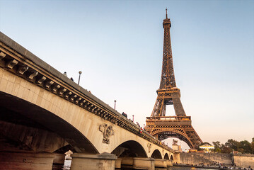 A lighted Eiffel Tower in Paris France, at sunset