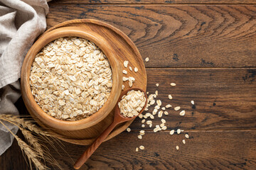 Wall Mural - Rolled oats or oat flakes in wooden bowl