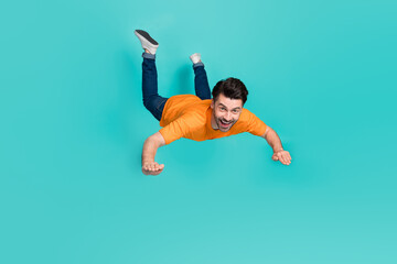 Sticker - Full body photo of crazy guy playing air gliding flying isolated on cyan color background