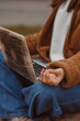 © Dzmitry - Crop female freelancer with yoga mudra sitting with laptop and meditating during break in work in nature