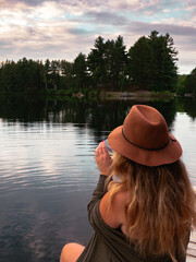 Canvas Print - Lake with wooden platform and woman smiling