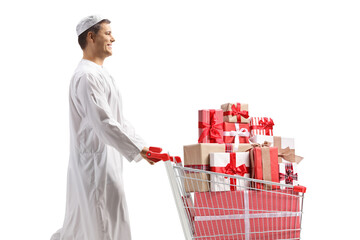 Wall Mural - Muslim man walking and pushing a shopping cart full of presents