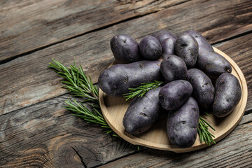 Wall Mural - Purple sweet potatoes on wooden background, Batata potato. vegan food ingredient. banner, menu, recipe place for text, top view