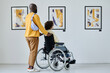 © AnnaStills - Young woman with disability visiting art gallery together with young man