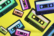 Pop music style attributes eighties, retro old school concept. Multicolored audio cassette levitates on a bright blue creative background.