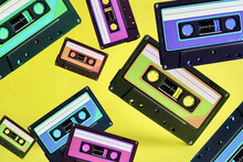 Pop Music Style Attributes Eighties, Retro Old School Concept. Multicolored Audio Cassette Levitates On A Bright Blue Creative Background.