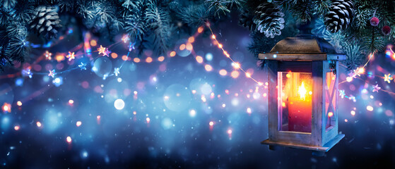 Wall Mural - christmas lantern glowing in the night - candlelight hanging fir branches with defocused snowflakes 