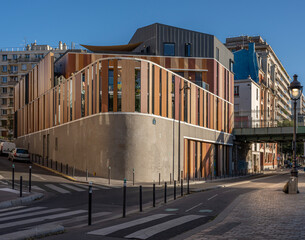 Wall Mural - Paris, France - 10 08 2022: Flandres district. Modern wooden facade of building at sunset