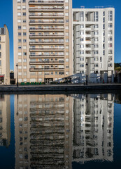 Wall Mural - Paris, France - 11 08 2022: La Villette Park. View of the Canal of the Basin of the villette with reflections of buildings