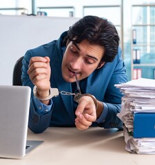 Wall Mural - Chained male employee unhappy with excessive work