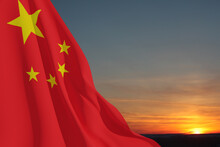 Close Up Waving Flag Of China On Background Of Sunset Sky. Flag Symbols Of China. National Day Of The People's Republic Of China. 1st October. 3d Rendering.