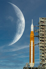 Orion Spacecraft On Launch Pad And Big Moon On Background. Artemis Space Program To Research Solar System. Elements Of This Image Furnished By NASA.