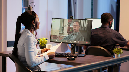 Wall Mural - Office worker talking to manager on videocall conference, using online communication teleconference with webcam. Meeting on remote web videoconference call to chat. Handheld shot.