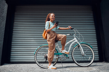 bicycle, woman and phone in city feeling excited and happy about message while outdoor in summer wit