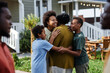 © Seventyfour - Waist up portrait of African American family embracing while gathering for Summer party outdoors