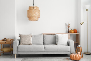 Canvas Print - Interior of modern living room with grey sofa and pumpkins