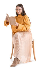 Wall Mural - Beautiful woman in yellow sweater reading book on white background