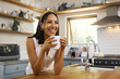 © N Lawrenson/peopleimages.com - Happy woman, coffee or tea in home kitchen and relax with a smile in the morning at house. Calm young person, smiling at peace and tea drink to wake up to start day with positive joyful thoughts