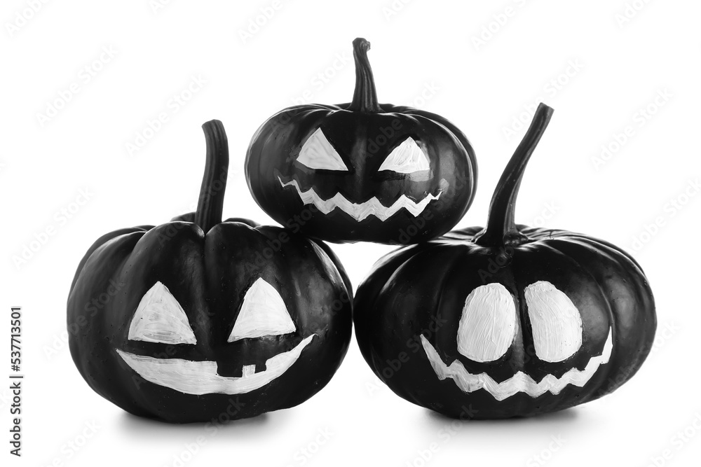 Black Halloween pumpkins with drawn face on white background