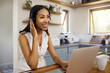 © N Lawrenson/peopleimages.com - Remote call center, telemarketing or support crm worker who help clients, customer and smile. Woman on a laptop, with a headset and working as a customer service or contact us professional from home