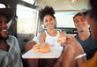© K Abrahams/peopleimages.com - Car, road trip and diversity friends with food, burger or snacks for SUV transportation journey in Australia. Van travel adventure, happy friendship or hungry relax group of people eating fast food