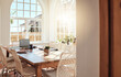 © Courtney Haas/peopleimages.com - Empty, wood and luxury dining room interior design in summer at a hotel, house or apartment with an elegant style. Hardwood table, furniture and chairs with sunlight from window in a modern home