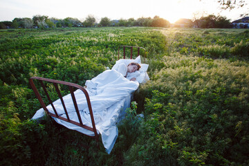 bed in a green field