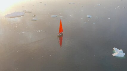 Wall Mural - Sail boat cruising among ice bergs during dusk, Disko Bay, Greenland.
Midnight sun, romantic view.
Climate change and global warming