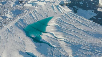 Wall Mural - Icebergs drone aerial video top view - Climate Change and Global Warming - Icebergs from melting glacier in icefjord in Ilulissat, Greenland. Arctic nature ice landscape in Unesco World Heritage Site.