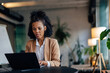 © bnenin - Concentrated businesswoman, working online, over the laptop.