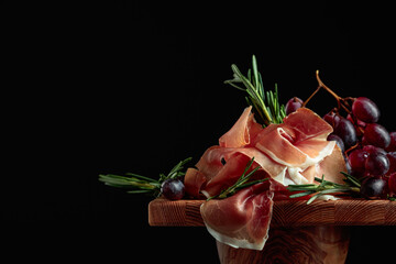 Wall Mural - Prosciutto with grapes and rosemary.
