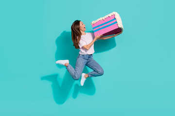 Wall Mural - Full size photo of gorgeous woman straight hairstyle wear striped t-shirt flying eat big piece of cake isolated on teal color background