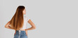 © Lustre Art Group  - Rear view portrait of young redhead girl with long hair posing in casual clothes isolated over grey studio background. Flyer