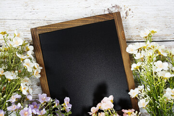 Sticker - Empty Chalkboard mockup space for text message with flower decoration top view on wooden background