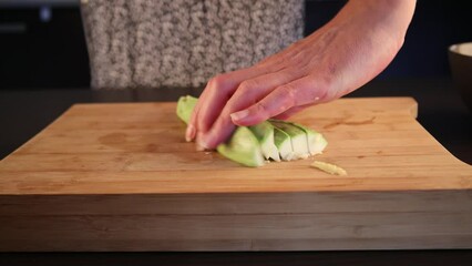 Canvas Print - woman hands cutting zucchini at home close up