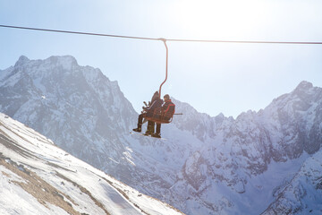 Wall Mural - People are lifting on open lft high up in Caucasus mountains