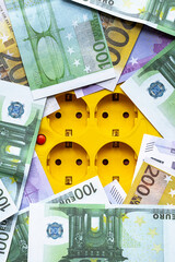 Electric socket euro currency banknotes, increasing electric prices. European money for energy costs.