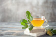 Sage herbal tea in a glass cup with fresh  leaves on wooden background. Natural medicine and healthy  herbs concept. Copy space