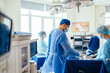 © Iryna - Rear view of surgical team making operation in sterile medical room. Selective focus.