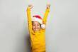 © millaf - Little black child win-win! Kid boy in Santa hat having fun on white background