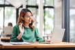 © Daenin - Asian business woman Video call in a teleconference and greet the result..Girl using laptop to video call her friends.
