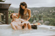 © BGStock72 - Young couple enjoying in outdoor hot tub on vacation