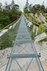 Sticker - Beautiful suspension bridge leading to the trees and mountains in canton Valais