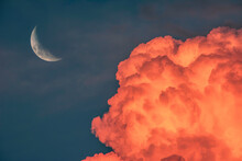 Moon In The Sky At Sunset With Red Clouds