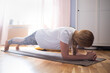 © Viktor Koldunov - Exercising At Home. Sporty caucasian woman ng yoga plank